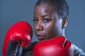 Face portrait of young angry and defiant black afro American sport woman in boxing gloves training and posing as a dangerous figh Royalty Free Stock Photo