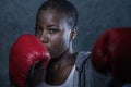 Face portrait of young angry and defiant black afro American sport woman in boxing gloves training and posing as a dangerous figh Royalty Free Stock Photo