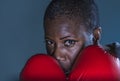 Face portrait of young angry and defiant black afro American sport woman in boxing gloves training and posing as a dangerous figh Royalty Free Stock Photo