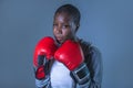 Face portrait of young angry and defiant black afro American sport woman in boxing gloves training and posing as a dangerous figh Royalty Free Stock Photo