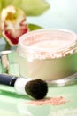Face powder and orchid flower Royalty Free Stock Photo