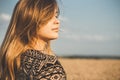 Face profile of romantic young woman enjoying sunset on wheat field, girl breathe breathes deeply , freedom and relaxation concept Royalty Free Stock Photo