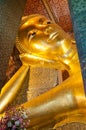 Face of Reclining Buddha gold statue in Bangkok, Thailand Royalty Free Stock Photo