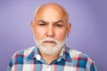 Face of 60s elderly retired mature aged pensioner. Serious old mature senior man with grey beard on studio background. Royalty Free Stock Photo