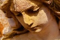 Face of sad beautifuul angel as symbol of pain, fear and end of life. Close up fragment of an ancient stone statue Royalty Free Stock Photo