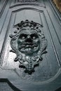 Face sculpted in wood on a front door