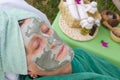 The face of senior woman is covered by facial clay mask Royalty Free Stock Photo