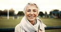 Face, senior woman and smile on park bench on vacation, holiday or travel in winter. Portrait, happy and elderly person Royalty Free Stock Photo