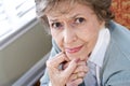 Face of serious elderly woman staring at camera