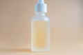 Face serum in a glass package, bottle on a white neutral background. treatment for skin with oils, vitamins and collagen. Royalty Free Stock Photo