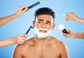 Face, shave and grooming with hands holding equipment for shaving or brushing hair in studio on a blue background Royalty Free Stock Photo