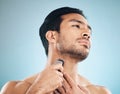 Face, shaving and electric razor with a man in studio on a blue background for personal hygiene, skincare or grooming Royalty Free Stock Photo