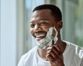 Face, shaving and razor with a black man grooming in the bathroom mirror of his home for beauty or skincare. Beard Royalty Free Stock Photo