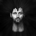 face shines through hands, psychological portrait of a person, double exposure, surreal portrait of a man covering his face and Royalty Free Stock Photo