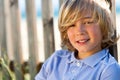 Face shot of handsome boy next to fence. Royalty Free Stock Photo