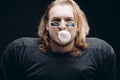 Determined American football player posing with painted face and chewing gum Royalty Free Stock Photo