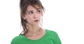 Face of a skeptical young woman in green shirt isolated.