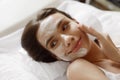 Face Skin Care. Beautiful Woman With Facial Cosmetic Mask At Spa