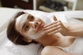 Face Skin Care. Beautiful Woman With Facial Cosmetic Mask At Spa Royalty Free Stock Photo