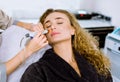 Face Skin Care. Close-up of pretty blond curly woman getting facial hydro microdermabrasion peeling treatment at Royalty Free Stock Photo