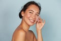 Face skin care. Smiling woman using oil blotting paper portrait