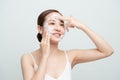 Face skin care. Woman applying facial cleanser on face closeup. Girl using cleansing cosmetic product on skin, washing face on Royalty Free Stock Photo