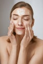 Face skin care. Woman cleaning facial skin with foam soap Royalty Free Stock Photo