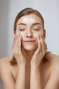 Face skin care. Woman cleaning facial skin with foam soap Royalty Free Stock Photo