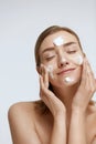 Face skin care. Woman cleaning facial skin with foam soap Royalty Free Stock Photo