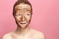 Face Skin Scrub. Portrait Of Smiling Female Model Applying Natural Coffee Mask, Face Scrub On Facial Skin. Closeup