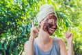 Face Skin Scrub. Portrait Of Smiling Female Model Applying Natural Coffee Mask, Face Scrub On Facial Skin. Closeup Of Beautif Royalty Free Stock Photo