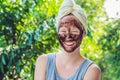 Face Skin Scrub. Portrait Of Smiling Female Model Applying Natural Coffee Mask, Face Scrub On Facial Skin. Closeup Royalty Free Stock Photo