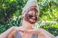 Face Skin Scrub. Portrait Of Smiling Female Model Applying Natural Coffee Mask, Face Scrub On Facial Skin. Closeup Royalty Free Stock Photo