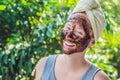 Face Skin Scrub. Portrait Of Smiling Female Model Applying Natural Coffee Mask, Face Scrub On Facial Skin. Closeup Royalty Free Stock Photo