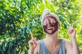 Face Skin Scrub. Portrait Of Smiling Female Model Applying Natural Coffee Mask, Face Scrub On Facial Skin. Closeup Royalty Free Stock Photo