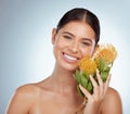 Face, skincare and happy woman with flowers in studio isolated on a white background. Portrait, natural and female model