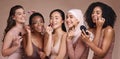 Face, skincare makeup and group of women in studio on a brown background. Beauty portrait, diversity and female models Royalty Free Stock Photo