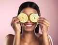 Face, skincare and smile of woman with orange slices in studio isolated on a pink background. Fruit, natural cosmetics Royalty Free Stock Photo