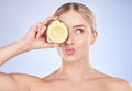 Face, skincare and woman with avocado in studio isolated on a blue background. Cosmetics kiss, fruit and thinking female