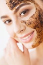 Face Skincare. Young charming girl makes a black charcoal mask o Royalty Free Stock Photo