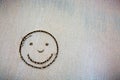 Face smail drawing in the sand . Royalty Free Stock Photo