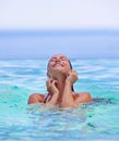 Face, smile and summer with woman in swimming pool for travel, holiday or vacation on blue sky. Tropical, wellness and Royalty Free Stock Photo