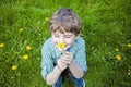 Face of smiling happy boy outside smelling flowers Royalty Free Stock Photo