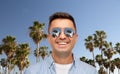 Face of smiling man in sunglasses over palm trees Royalty Free Stock Photo