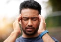 Face of sports man, headache and pain outdoor for injury, vertigo and tired of exercise problem. Sad asian athlete, sick Royalty Free Stock Photo