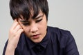 Face of stressed young androgynous Asian transgender woman