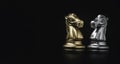 Face to face of golden and silver knight horse chess on black background with copy space , Business strategy and competition Royalty Free Stock Photo