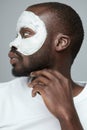 Face Treatment. Skin Care Procedure For Man. Model Applying White Facial Mask During Spa Relaxation. Royalty Free Stock Photo