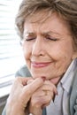 Face of upset elderly woman with eyes closed