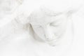 Face of white angel against white background. Ancient statue Royalty Free Stock Photo